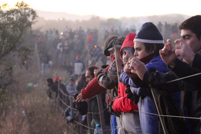 People on footbridge during foggy weather