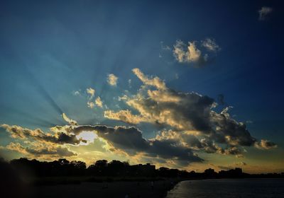 Silhouette trees against sky during sunset