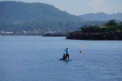 Man kayaking on sea