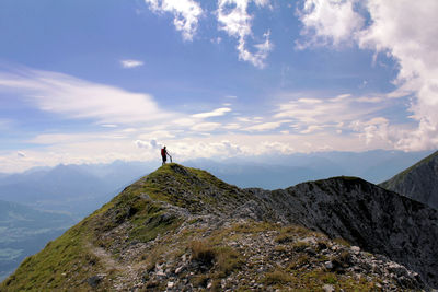 Woman on mountain against sky