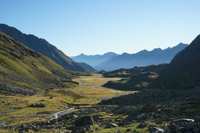 Scenic view of mountains against clear blue sky