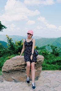 Portrait of woman standing against plants