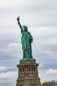 Low angle view of statue of liberty against sky