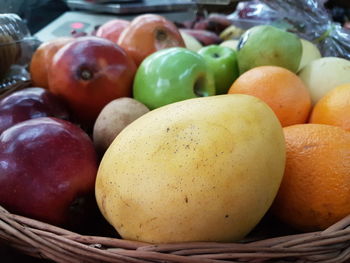 Close-up of various fruits in wicker basket at store
