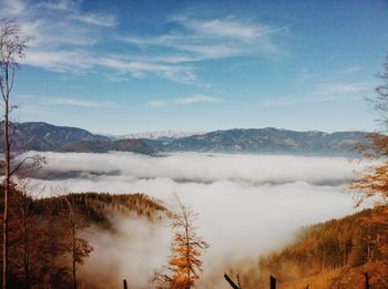 Scenic view of mountains against sky during foggy weather