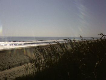 Scenic view of beach against clear sky