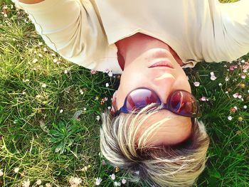 High angle view of woman lying on grassy field