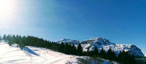 Scenic view of snowcapped mountains against clear sky