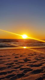 Scenic view of beach against sky during sunset