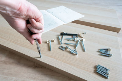 Cropped hand of man working on table