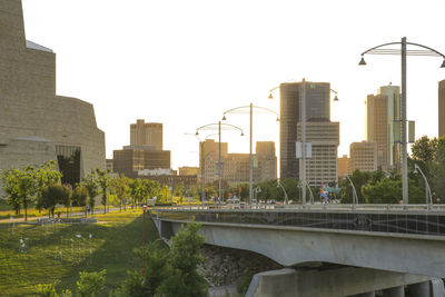 Bridge by buildings against sky in city