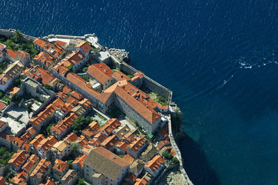 High angle view of buildings by sea