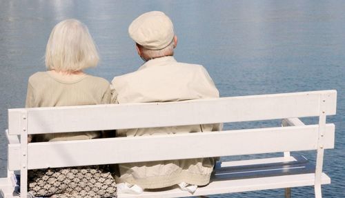 Rear view of old couple sitting outdoors