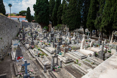 High angle view of cemetery and trees in city