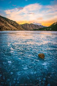 Scenic view of lake against sky at sunset