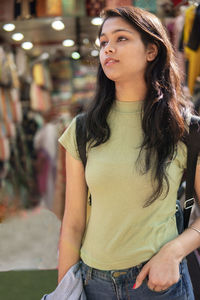 Portrait of a beautiful young woman looking away