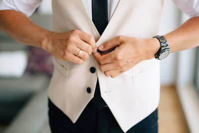 Midsection of man wearing blazer