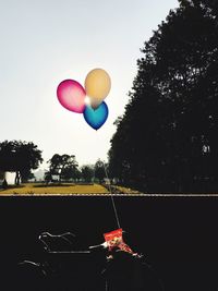 Low angle view of balloons flying against sky