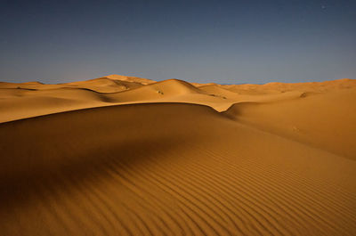 Scenic view of desert against clear sky