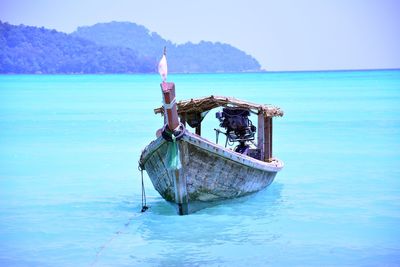 Boat in sea against blue sky
