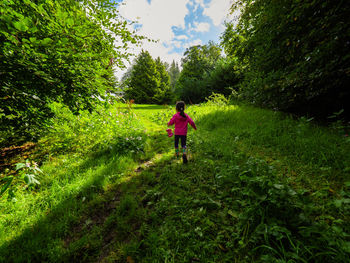 Full length of woman walking on dirt road