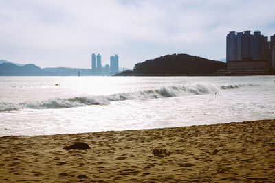 View of beach with city in background