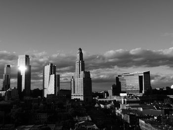 View of skyscrapers against cloudy sky