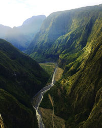 High angle view of valley and mountains against sky