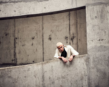 Full length portrait of woman in front of wall