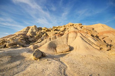 Rock formations on landscape against sky