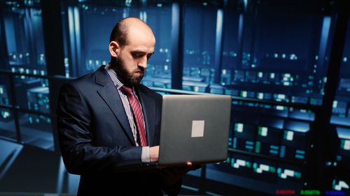 Portrait of businessman using digital tablet in office