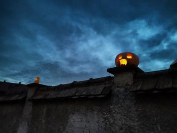 Low angle view of illuminated building against sky at dusk