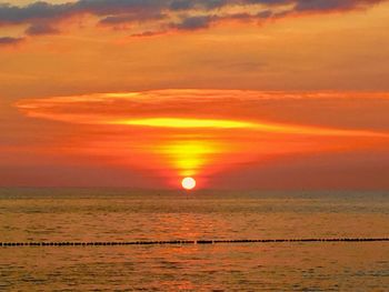 Scenic view of sea against orange sky