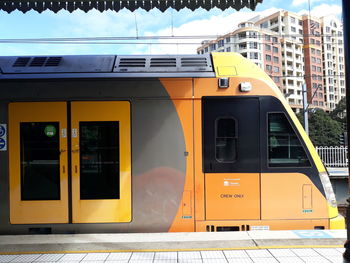 Yellow train on railroad station platform
