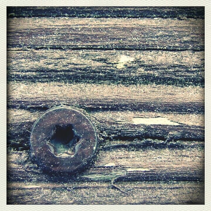 transfer print, auto post production filter, wood - material, close-up, wooden, wood, metal, rusty, old, outdoors, textured, beach, no people, day, circle, weathered, sand, metallic, abandoned, high angle view