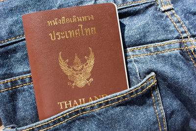 Close-up of thai passport in jeans pocket