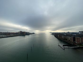 Scenic view of sea by buildings against sky