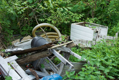 High angle view of abandoned seat in forest