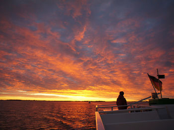 Scenic view of sea against dramatic sky during sunset