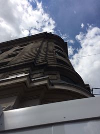 Low angle view of building against cloudy sky