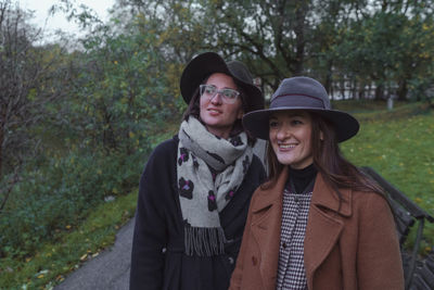 Portrait of a smiling two women against trees