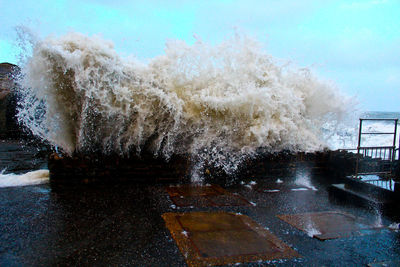 Close-up of splashing water against sky