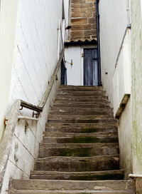 Low angle view of staircase leading towards old building
