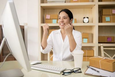 Portrait of a smiling young woman using smart phone