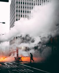 People on street amidst buildings in city