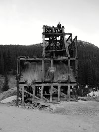 Abandoned built structure on field against sky