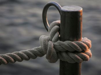 Close-up of rope tied on wooden post