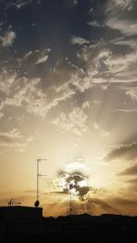 Silhouette electricity pylon against sky during sunset