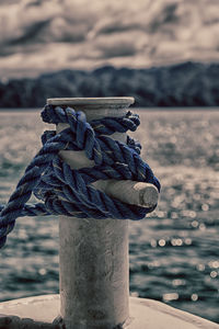 Close-up of rope tied on wooden post