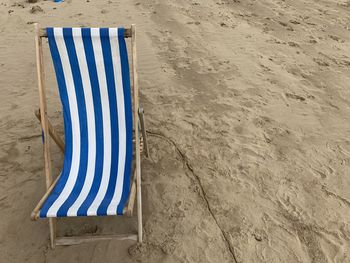 High angle view of deckchair on beach